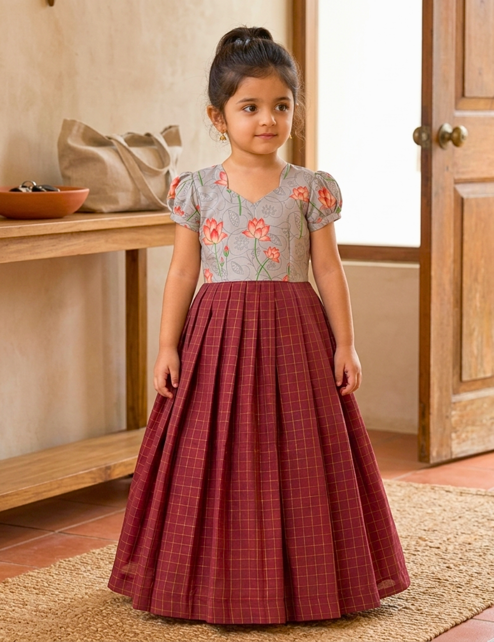 Discover a premium girls’ ethnic gown featuring a grey floral bodice and burgundy pleated skirt. Perfect for weddings, festivals and special occasions.